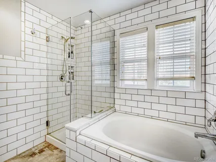 a bathroom with a bathtub and shower