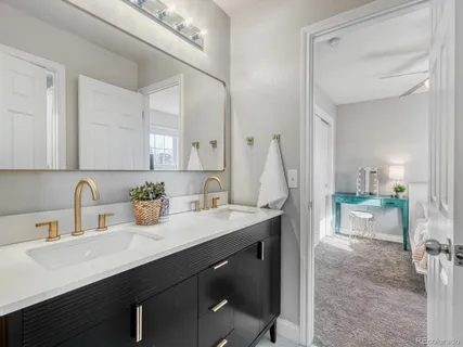 a kitchen with a sink cabinets and wooden floor