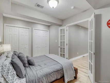 a bedroom with a bed and cabinets