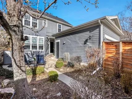 a view of a house with a yard covered in snow