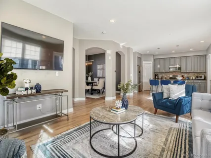 a living room with furniture kitchen and a stove