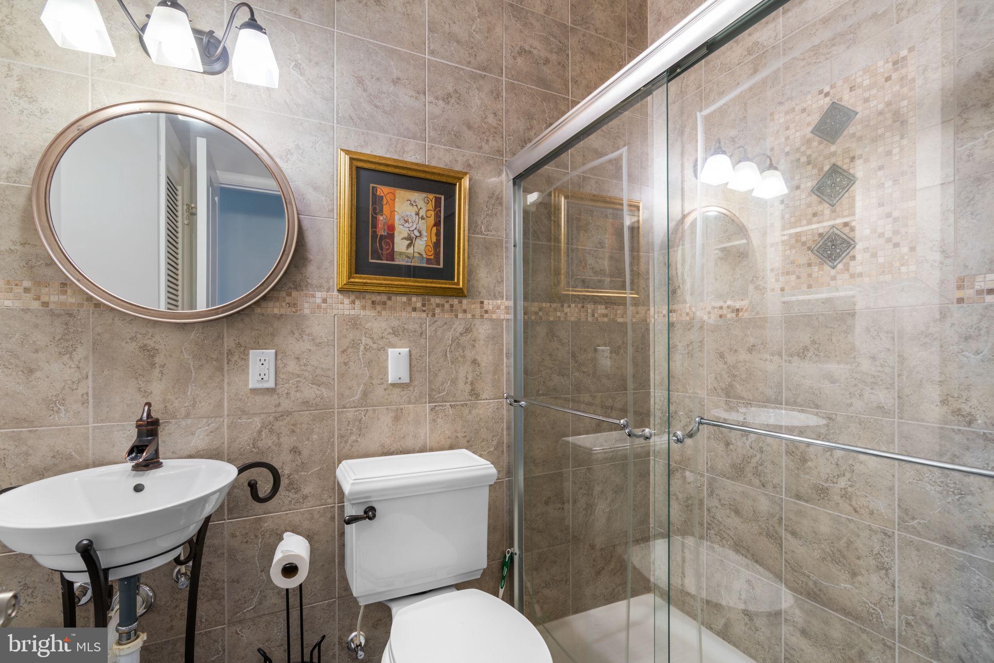 370 Magothy Road Severna Park, MD 21146 - Photo 16 of 64 a bathroom with a toilet a sink and mirror