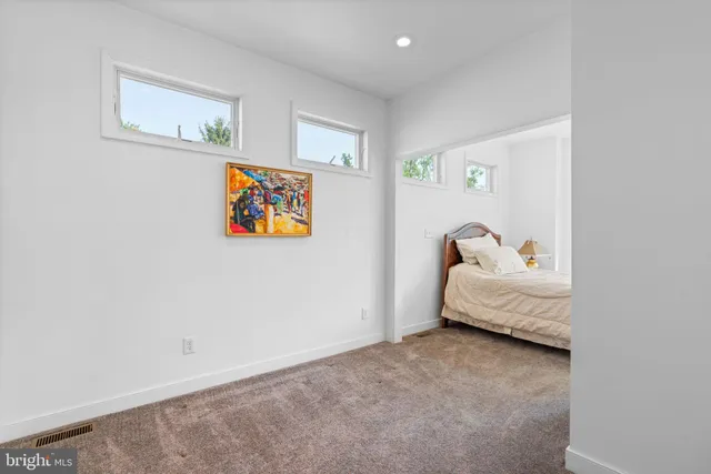 a spacious bedroom with a large bed and a fireplace