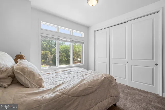 a bedroom with a bed and a night stand