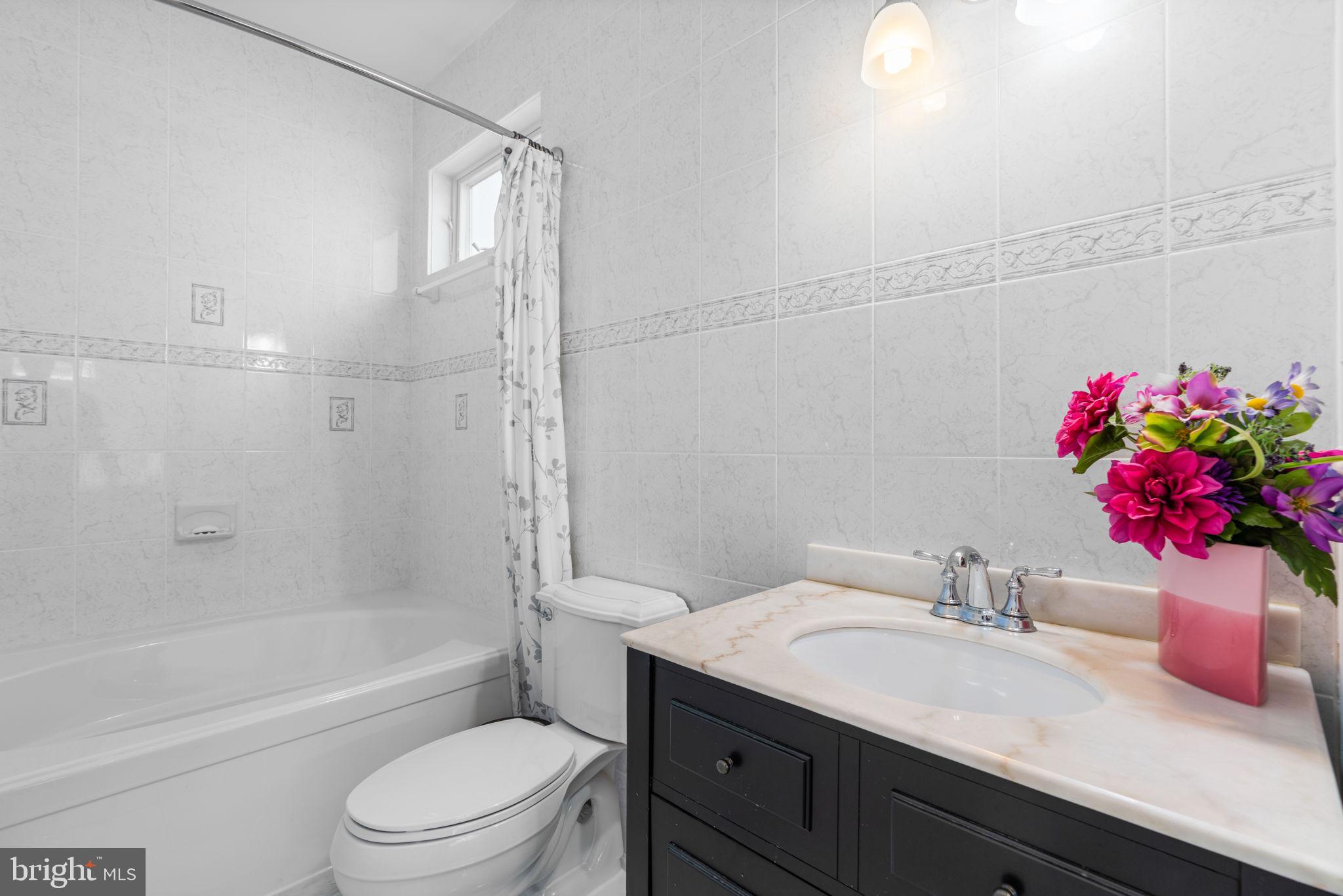 370 Magothy Road Severna Park, MD 21146 - Photo 20 of 64 a bathroom with a granite countertop sink a toilet and shower