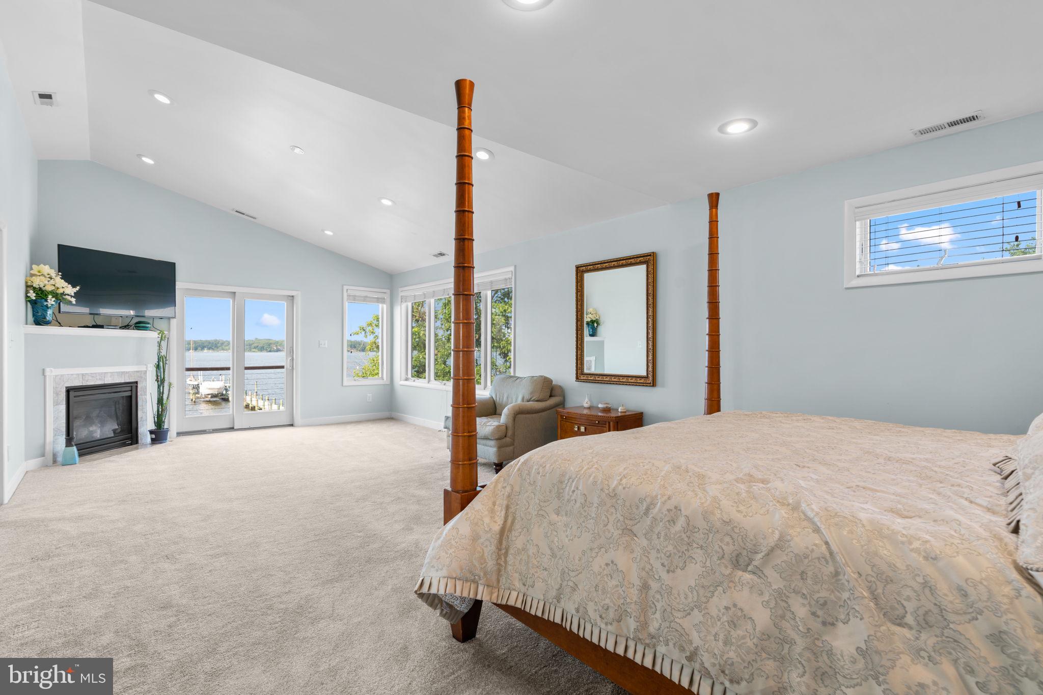 370 Magothy Road Severna Park, MD 21146 - Photo 21 of 64 a spacious bedroom with a large bed and a fireplace