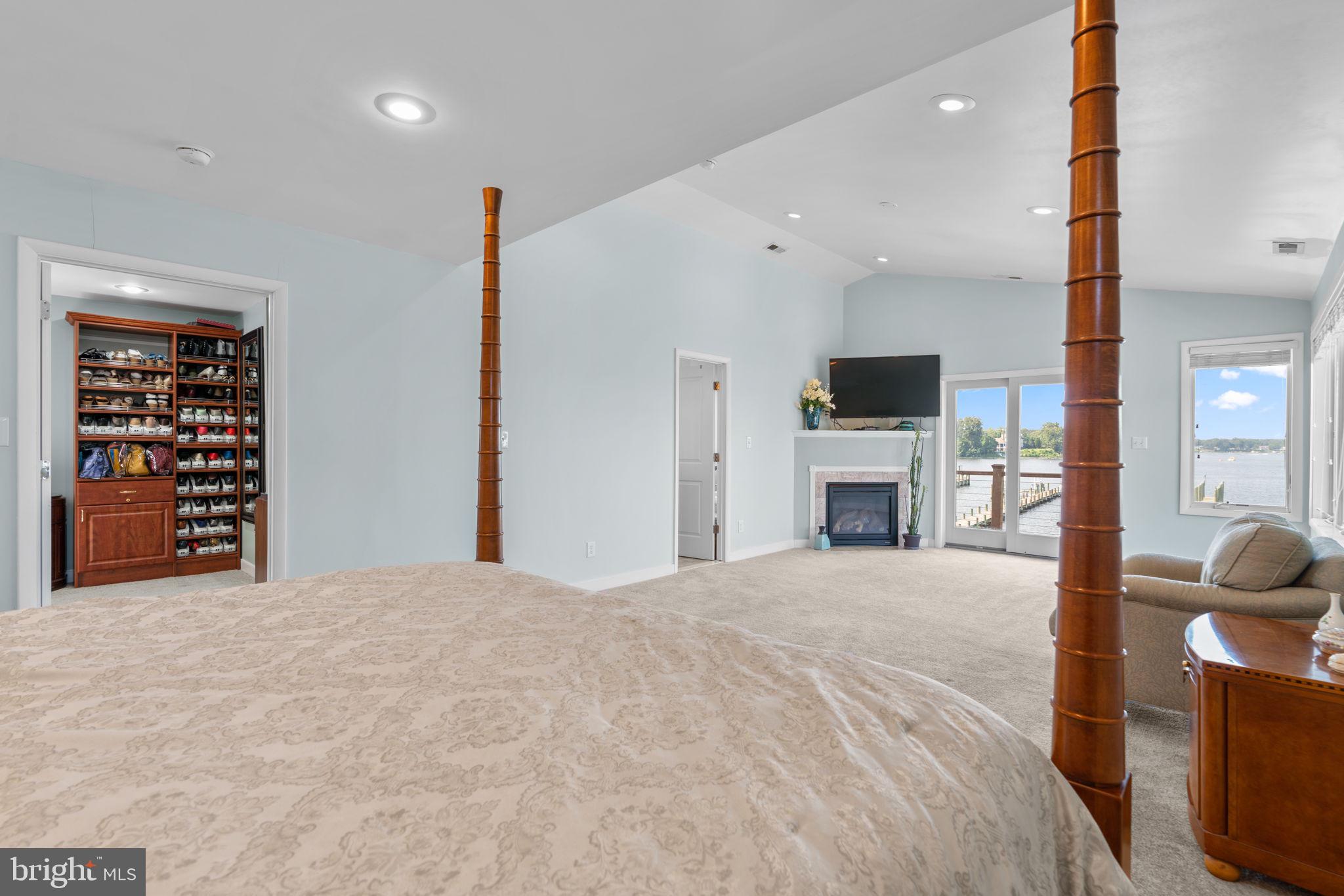 370 Magothy Road Severna Park, MD 21146 - Photo 23 of 64 a bedroom with a large bed and a fireplace