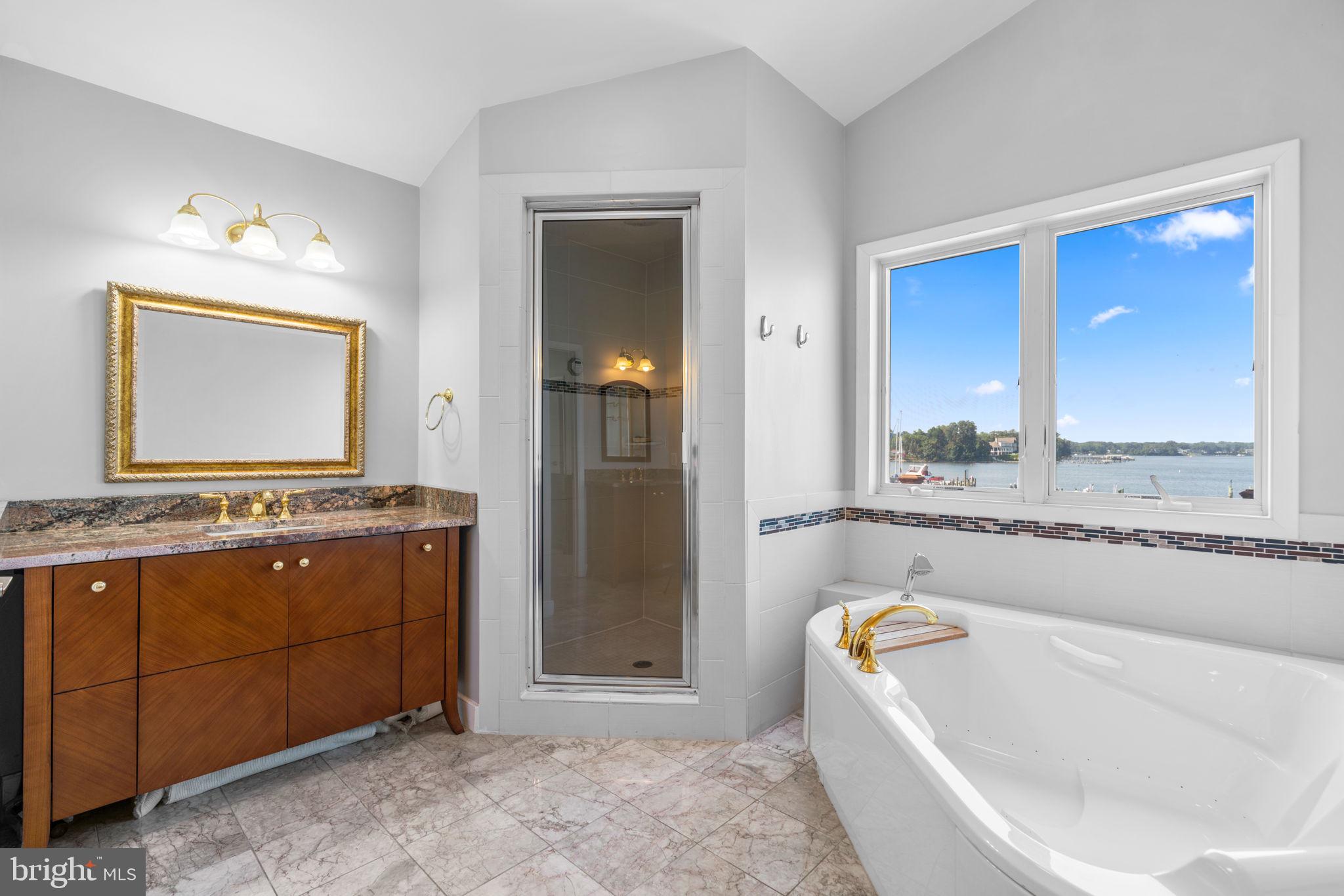 370 Magothy Road Severna Park, MD 21146 - Photo 25 of 64 a bathroom with a tub a sink and a mirror