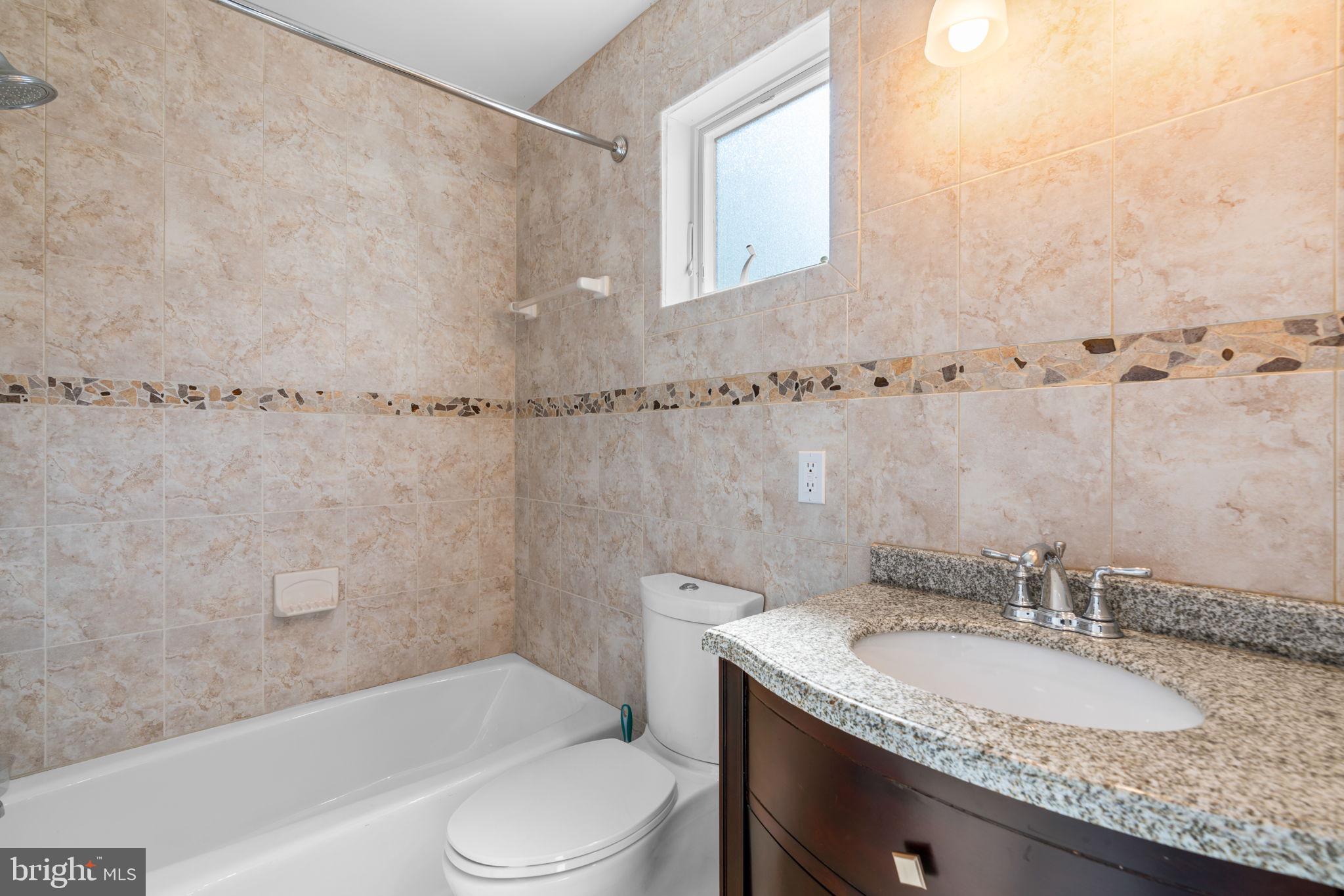 370 Magothy Road Severna Park, MD 21146 - Photo 29 of 64 a bathroom with a granite countertop sink a toilet and shower