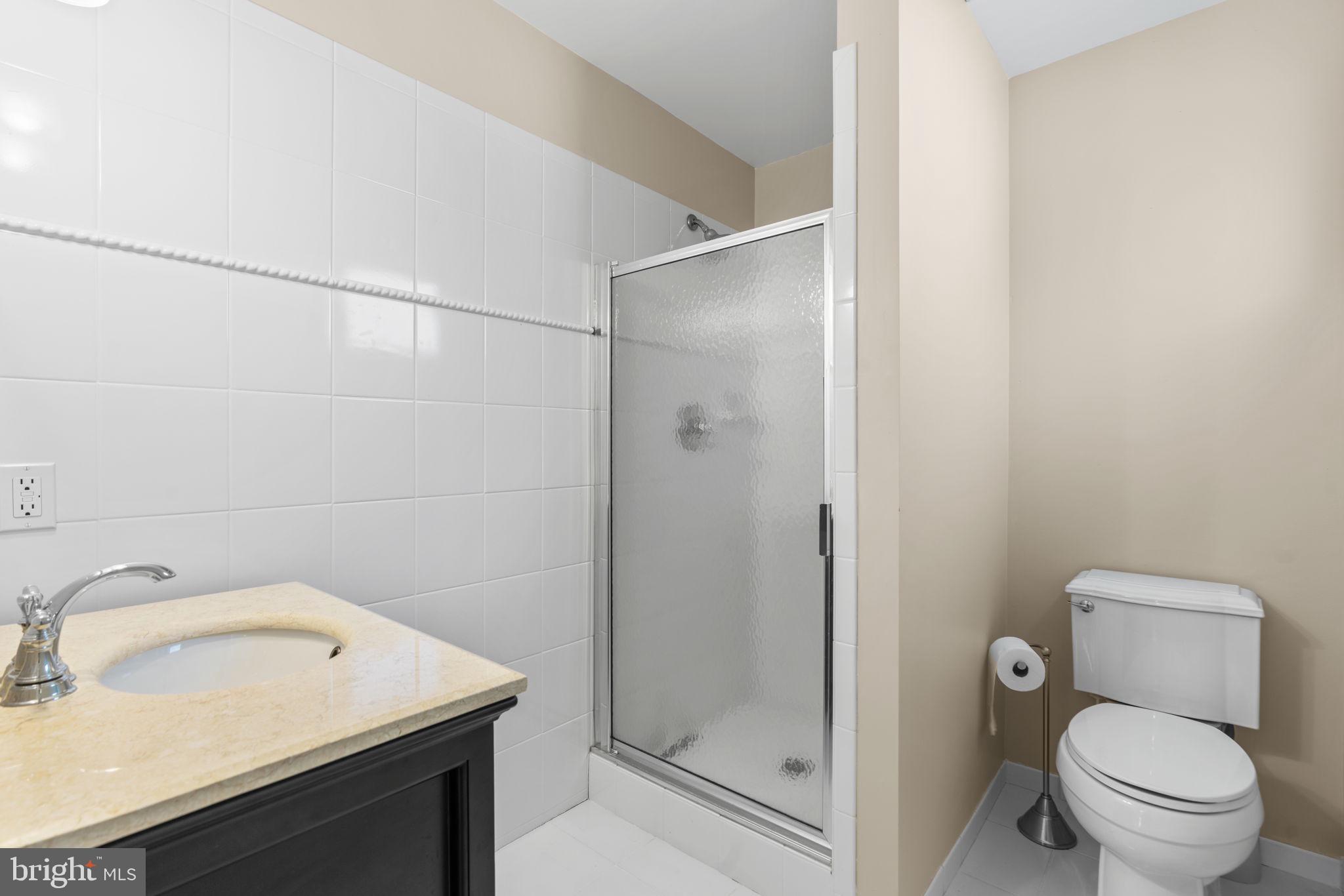 370 Magothy Road Severna Park, MD 21146 - Photo 35 of 64 a bathroom with a sink toilet and shower