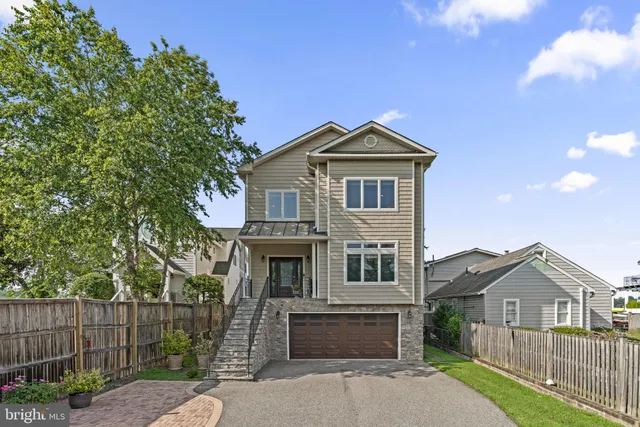 a kitchen with stainless steel appliances granite countertop a sink a stove and a wooden floors