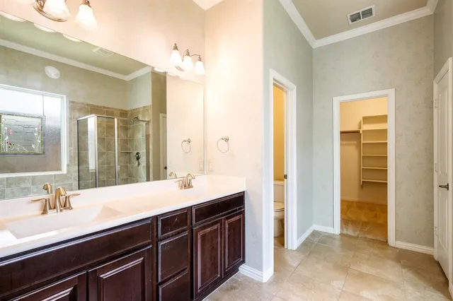 a bathroom with a sink double vanity and a mirror