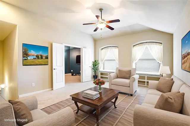 a living room with furniture and a large window