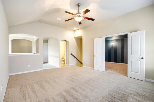 a view of an empty room with a ceiling fan