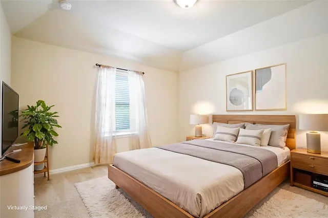 a bedroom with bed and a potted plant