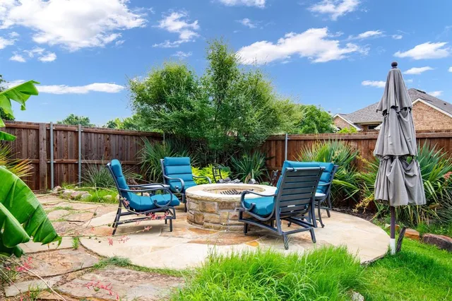 a view of backyard with seating space and trees
