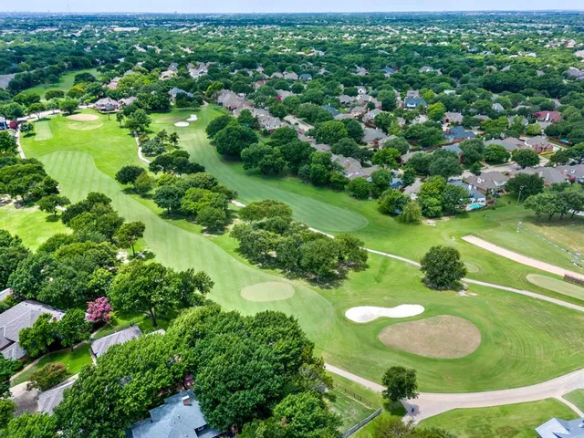 a view of a golf course with a swimming pool