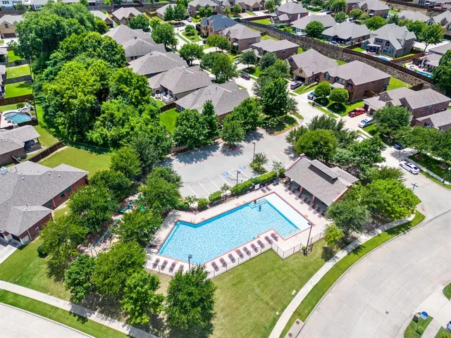 an aerial view of residential house with outdoor space and swimming pool