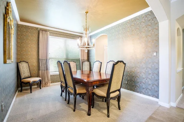 a view of a dining room with furniture and chandelier