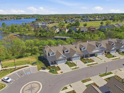an aerial view of residential house with outdoor space and lake view