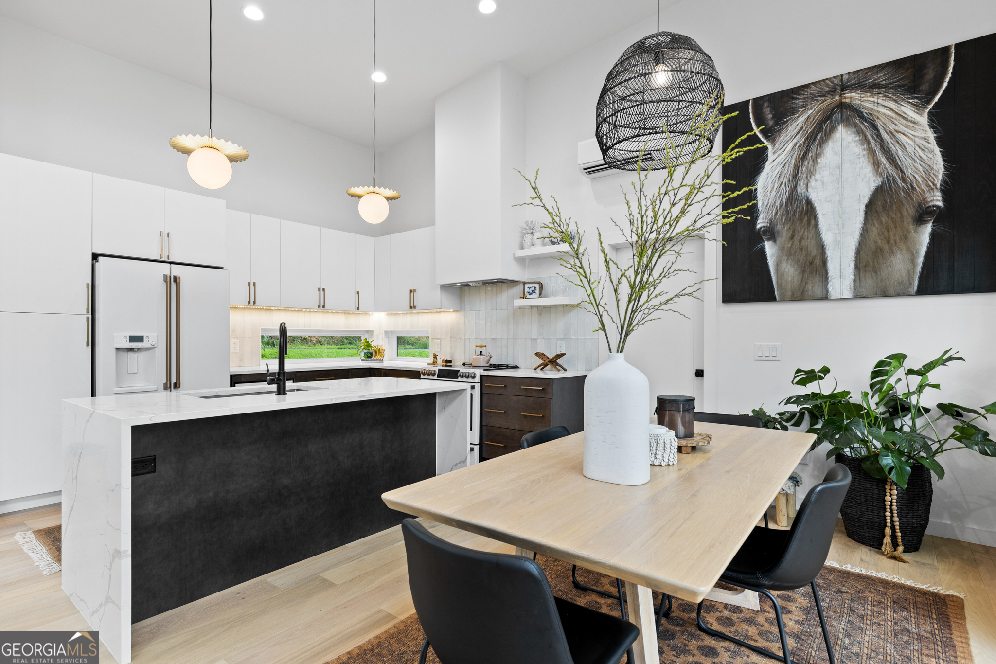 21 That Way Young Harris, GA 30582 - Photo 17 of 60 a kitchen with stainless steel appliances a table chairs and white cabinets