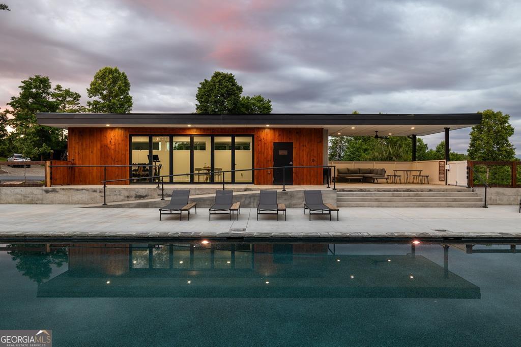 21 That Way Young Harris, GA 30582 - Photo 56 of 60 a view of house with swimming pool and a yard in front of it