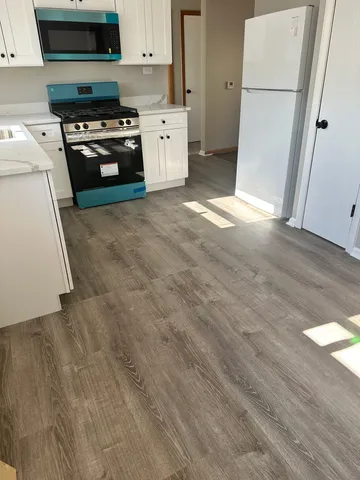 a kitchen with stainless steel appliances a refrigerator and a stove