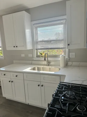a kitchen with a sink and cabinets