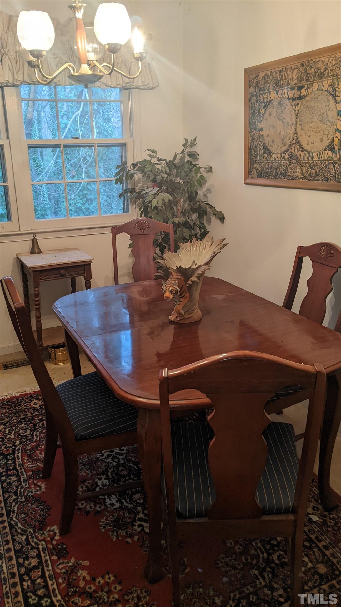 7804 Prospector Place Raleigh, NC 27615 - Photo 7 of 12 a view of a dining room with furniture and wooden floor