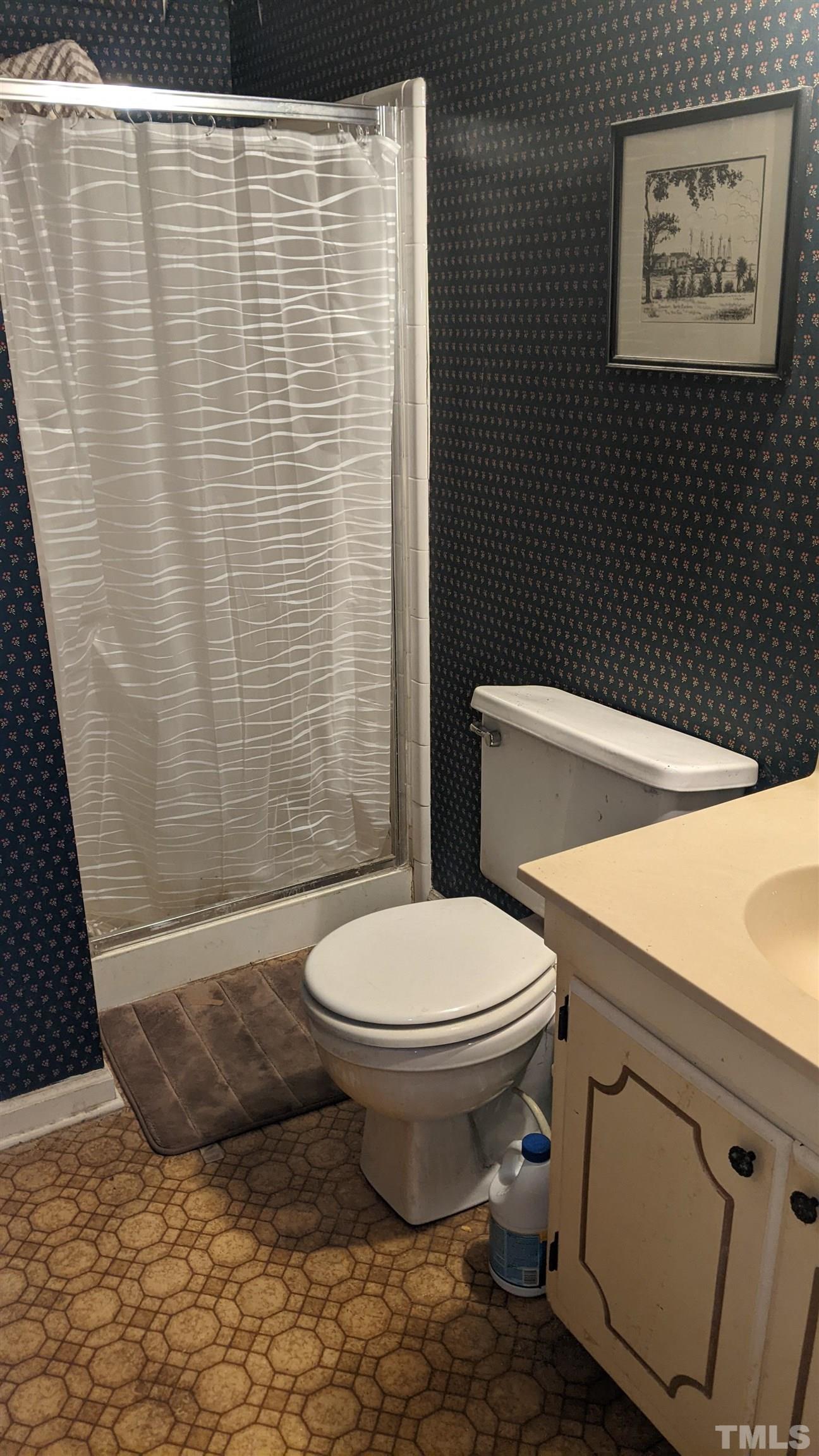 7804 Prospector Place Raleigh, NC 27615 - Photo 10 of 12 a bathroom with a toilet and a shower