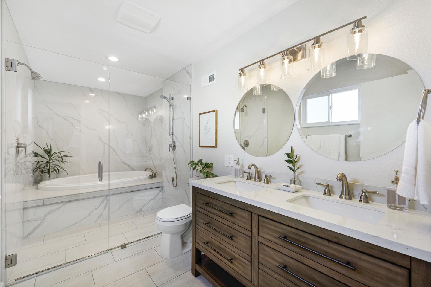6479 Barron Place Gilroy, CA 95020 - Photo 13 of 26 a spacious bathroom with a double vanity sink toilet mirror and bathtub