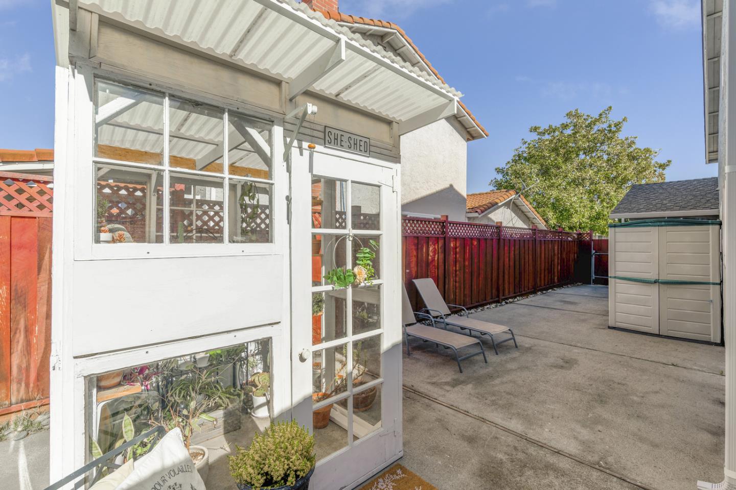 6479 Barron Place Gilroy, CA 95020 - Photo 24 of 26 a view of a backyard with table and chairs and wooden fence