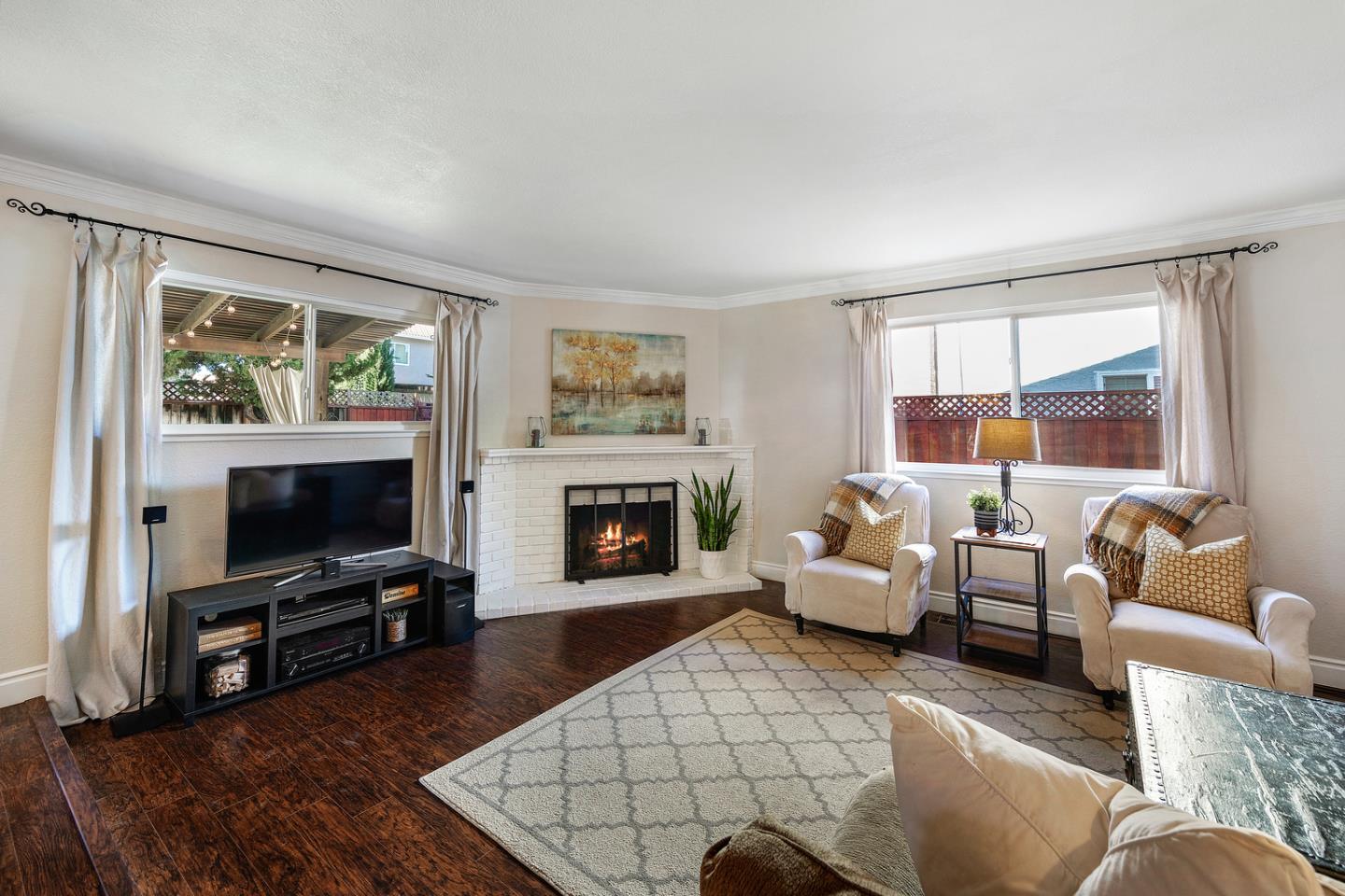 6479 Barron Place Gilroy, CA 95020 - Photo 3 of 26 a living room with furniture a flat screen tv and a fireplace