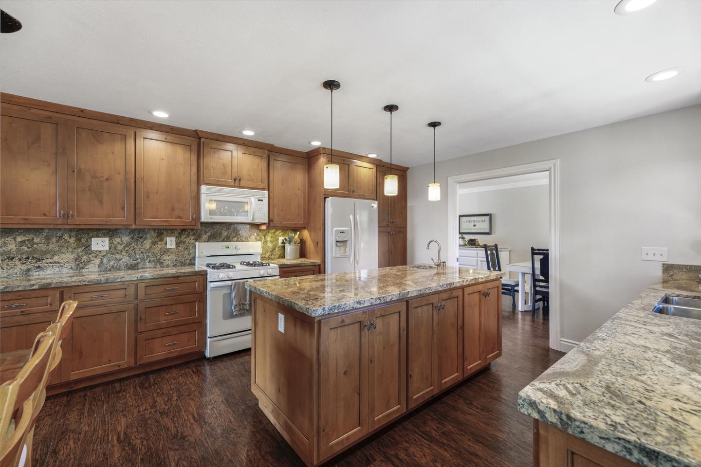 6479 Barron Place Gilroy, CA 95020 - Photo 6 of 26 a kitchen with stainless steel appliances granite countertop a sink stove and refrigerator