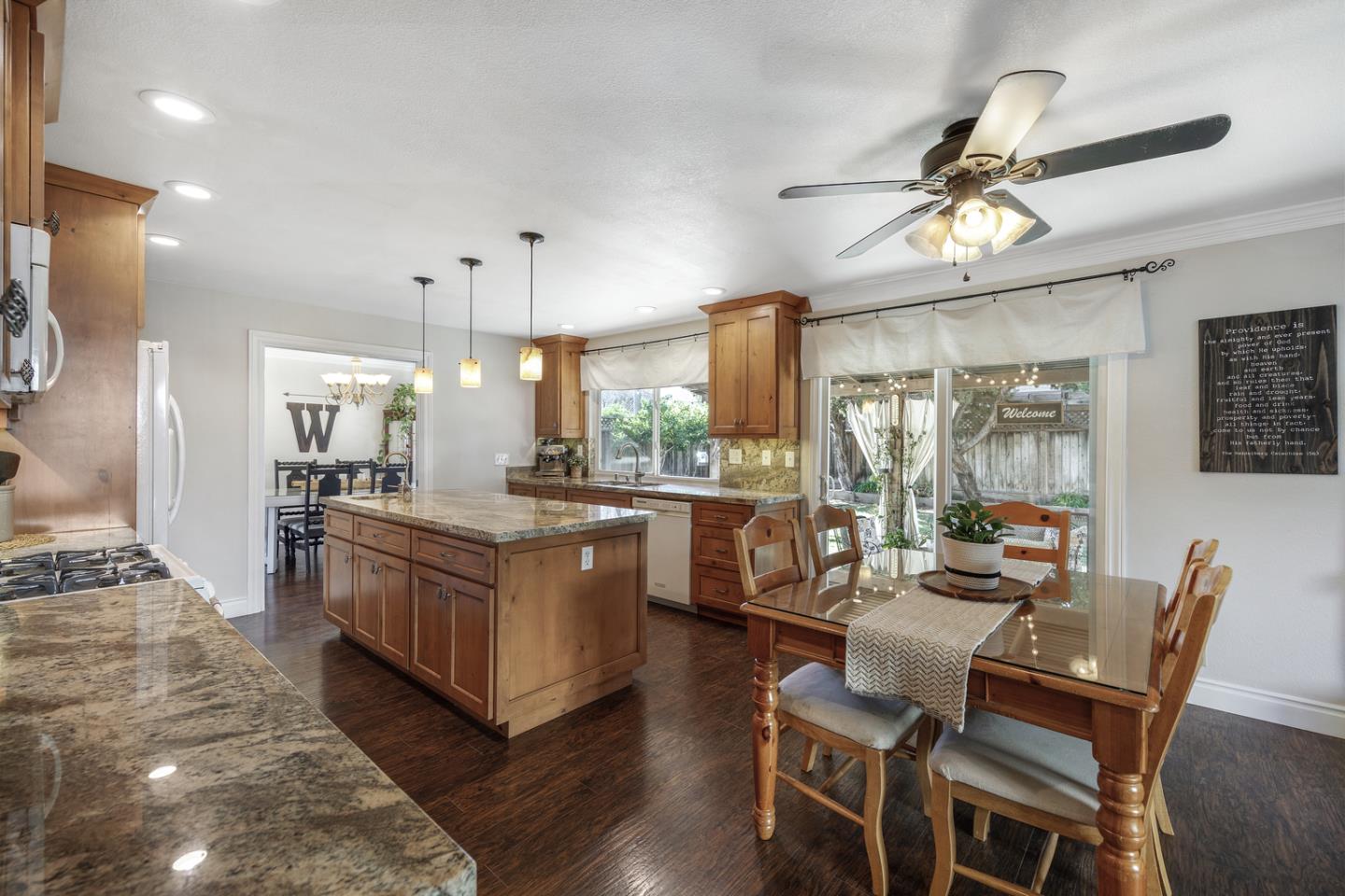 6479 Barron Place Gilroy, CA 95020 - Photo 7 of 26 a kitchen with stainless steel appliances granite countertop a stove and a refrigerator