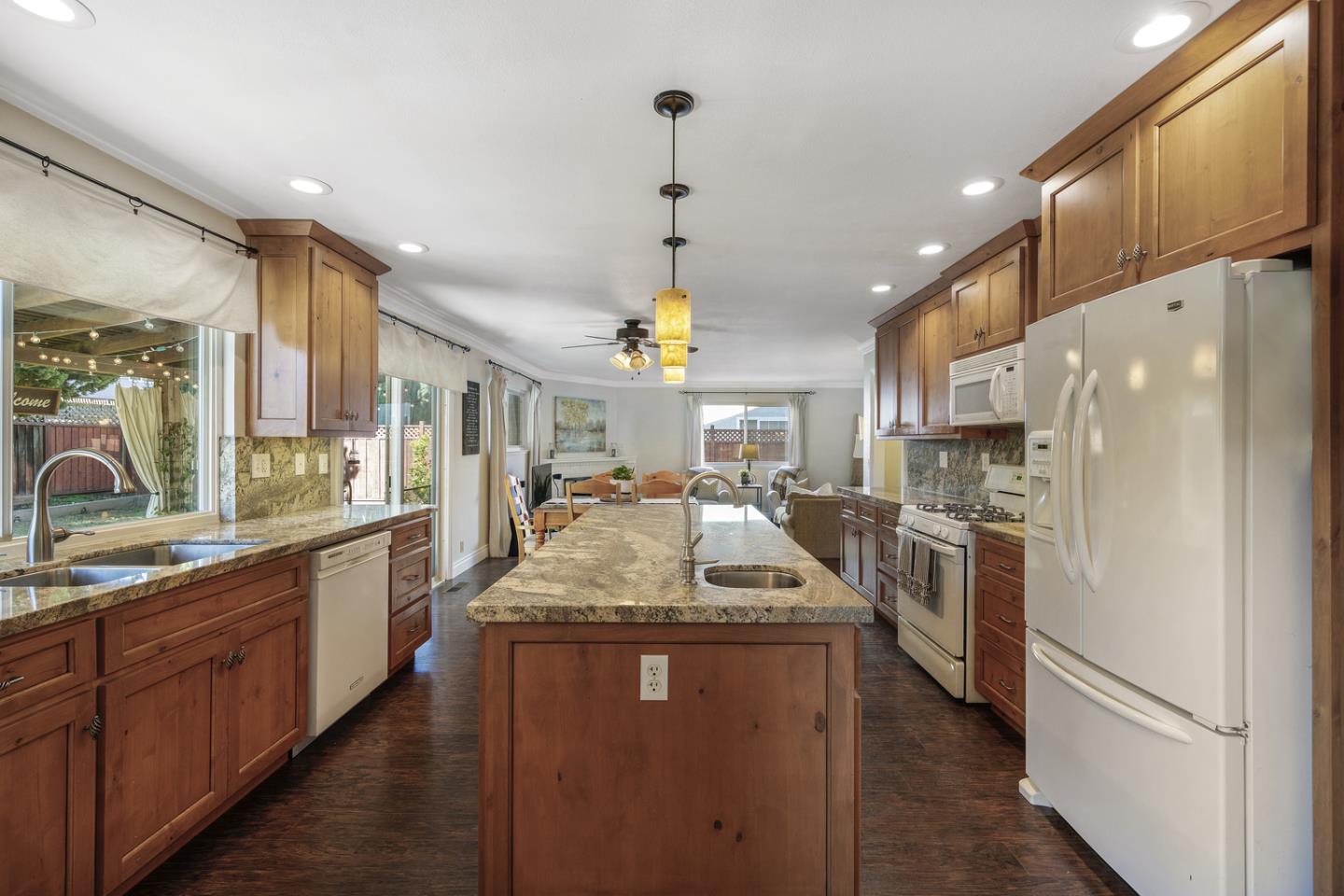 6479 Barron Place Gilroy, CA 95020 - Photo 8 of 26 a kitchen with sink a refrigerator and chairs