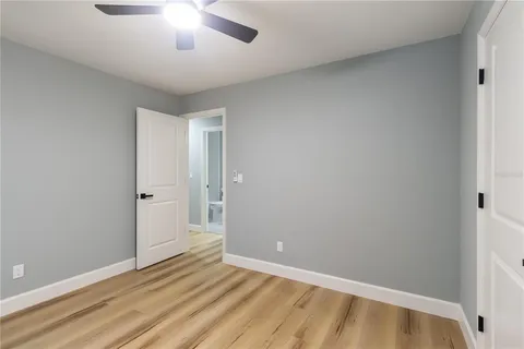 an empty room with windows and closet