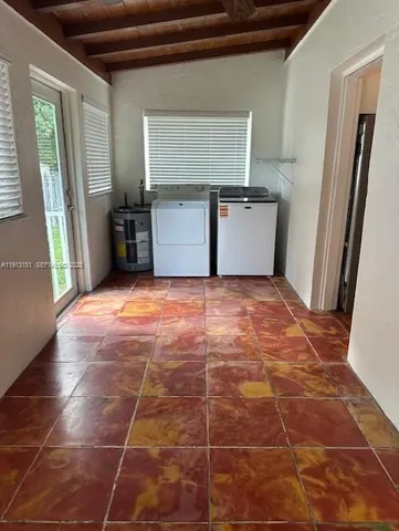 a view of a refrigerator in kitchen and a sink