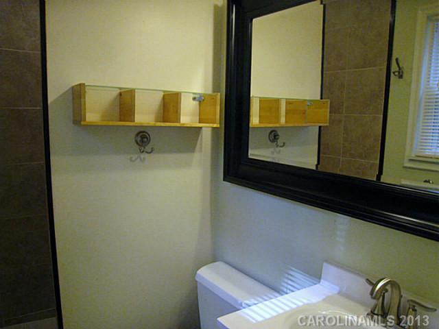 4242 Sudbury Road Charlotte, NC 28205 - Photo 11 of 16 a bathroom with a sink and a mirror