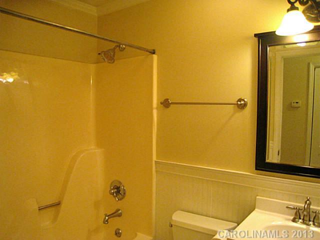 4242 Sudbury Road Charlotte, NC 28205 - Photo 9 of 16 a bathroom with a shower and a toilet