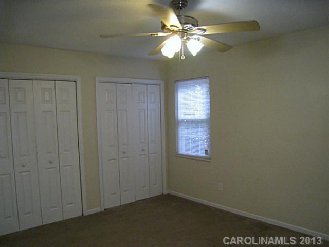 4242 Sudbury Road Charlotte, NC 28205 - Photo 10 of 16 an empty room with windows and fan