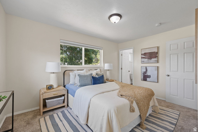 2370 Quail Run Circle East Sandy, UT 84093 - Photo 15 of 54 Carpeted room featuring a window with natural light, a ceiling-mounted light fixture, and a paneled door
