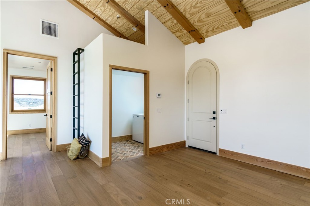 37219 Quarter Valley Road Temecula, CA 92592 - Photo 20 of 51 an empty room with wooden floor and a ceiling fan
