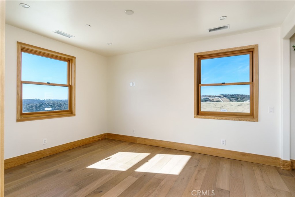 37219 Quarter Valley Road Temecula, CA 92592 - Photo 22 of 51 a view of an empty room with wooden floor and a window
