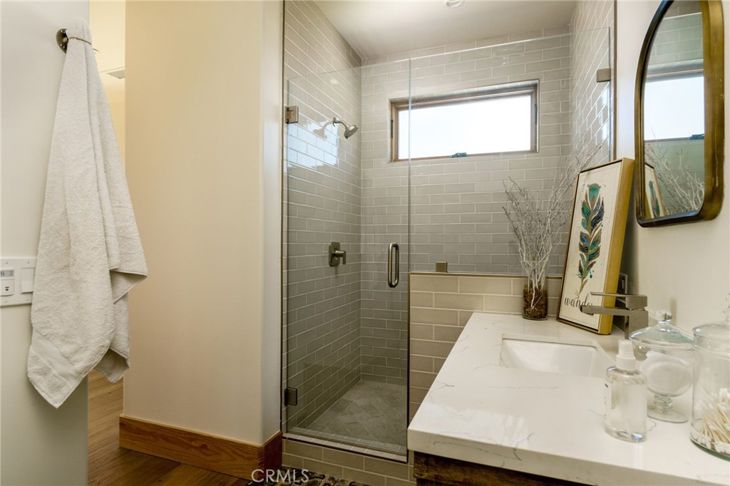 37219 Quarter Valley Road Temecula, CA 92592 - Photo 26 of 51 a bathroom with a sink a mirror and shower