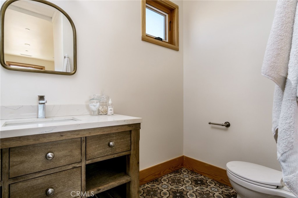 37219 Quarter Valley Road Temecula, CA 92592 - Photo 27 of 51 a bathroom with a granite countertop toilet sink and mirror