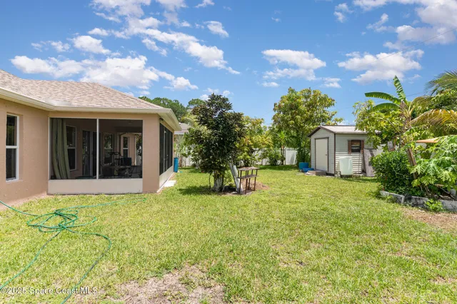 a view of a house with backyard and sitting area