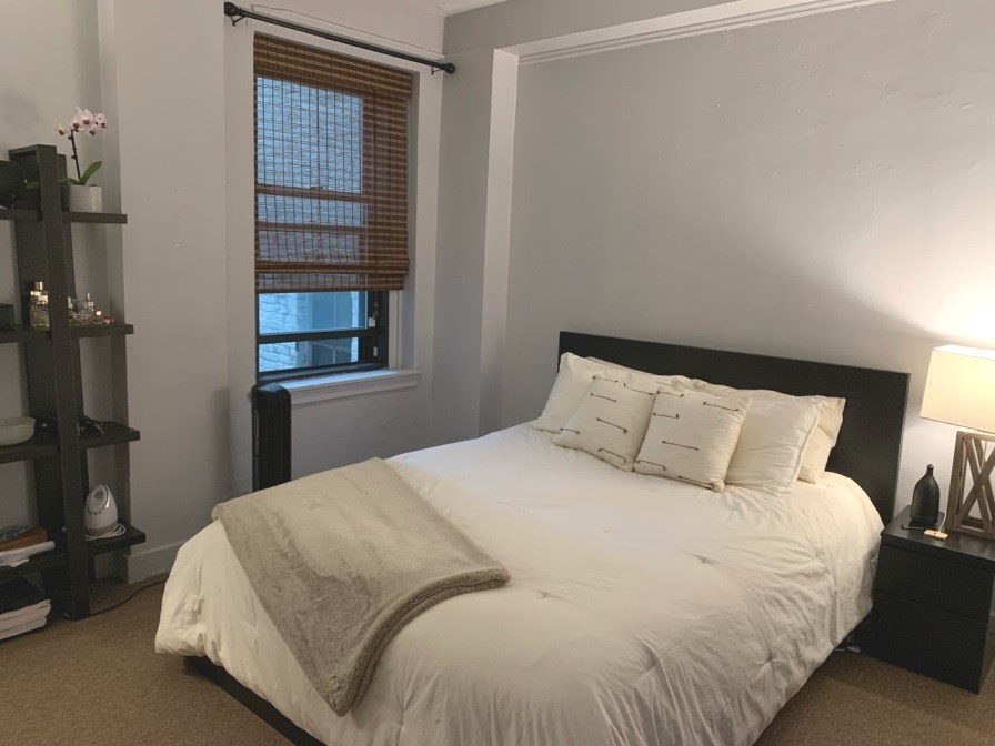 475 Commonwealth Avenue, Unit 401 Boston, MA 02215 - Photo 6 of 11 a large bed sitting in a bedroom next to a window