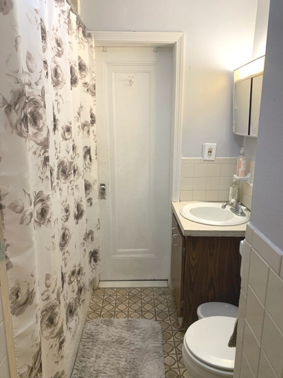 475 Commonwealth Avenue, Unit 401 Boston, MA 02215 - Photo 7 of 11 a bathroom with a sink a toilet and shower