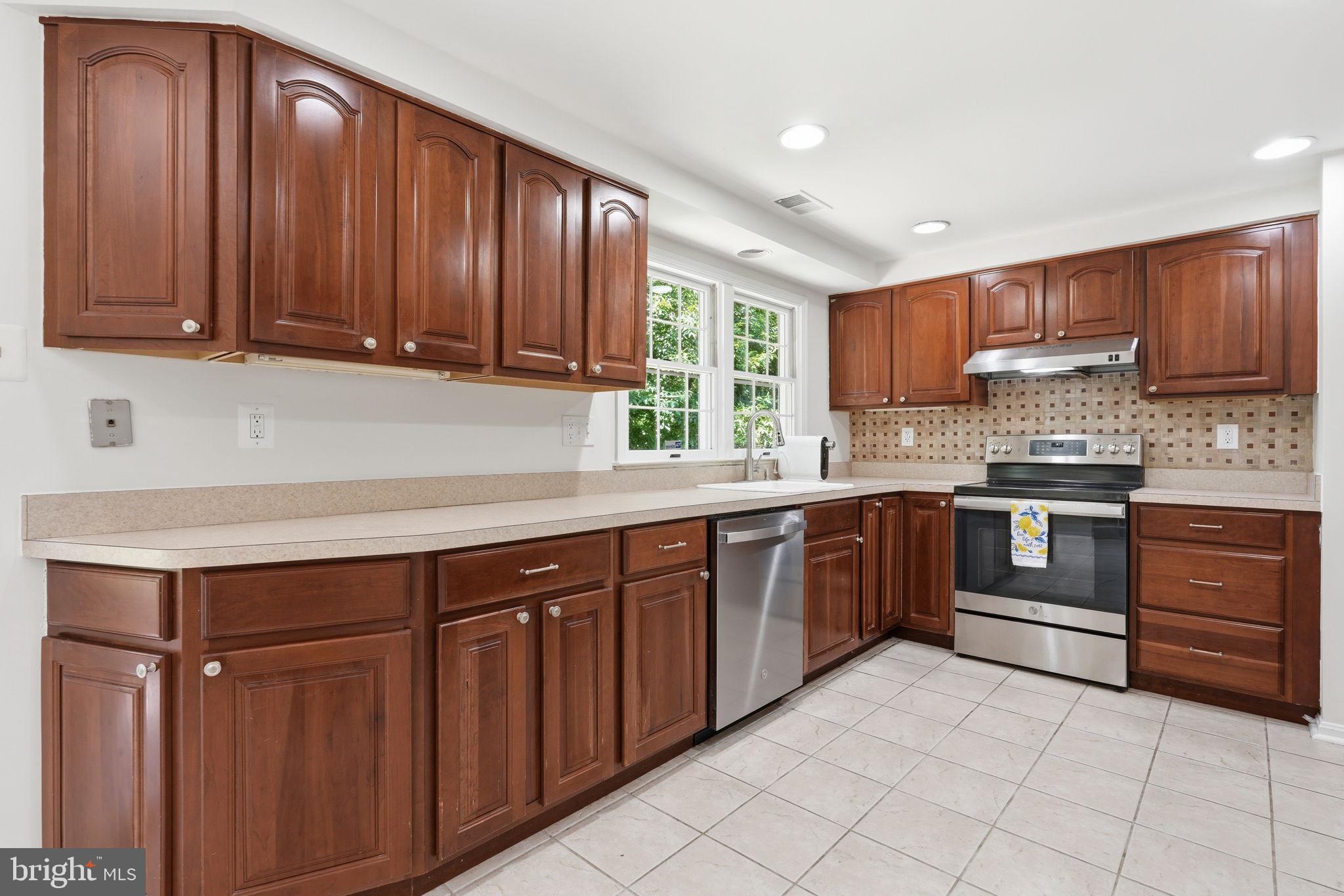 6017 Misty Arch Run Columbia, MD 21044 - Photo 8 of 39 Modern kitchen with rich wood cabinetry.